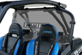A close-up of two black and blue RZR seats with harness seatbelts, shown behind the Polaris Rzr Turbo-S Rear Shield-Tinted 2018+ on the vehicle frame, featuring visible roll bars and a vented center section.