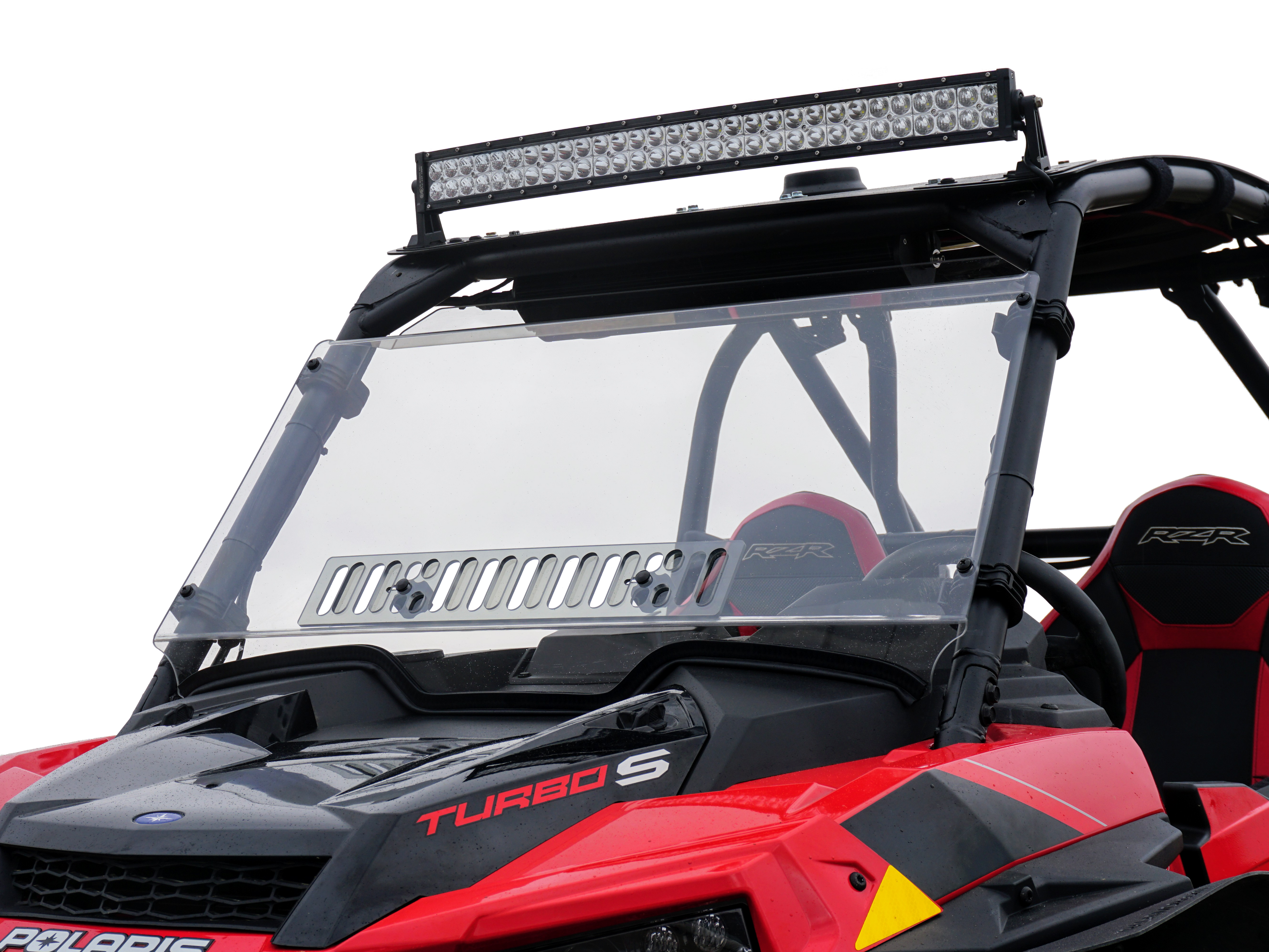 A close-up of a red Polaris RZR Turbo S (2018+) with a black frame, overhead LED light bar, RZR-branded black seats, angular styling, and a Rzr Turbo-S Scratch Resistant Venting Windshield.