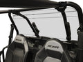 A Polaris RZR 900/1000 (New Style) Rear Windshield-GP made of clear polycarbonate is installed on a black-framed off-road vehicle with open roll cage, two black RZR-logo seats, and harness bars visible in the foreground. Background is blank.
