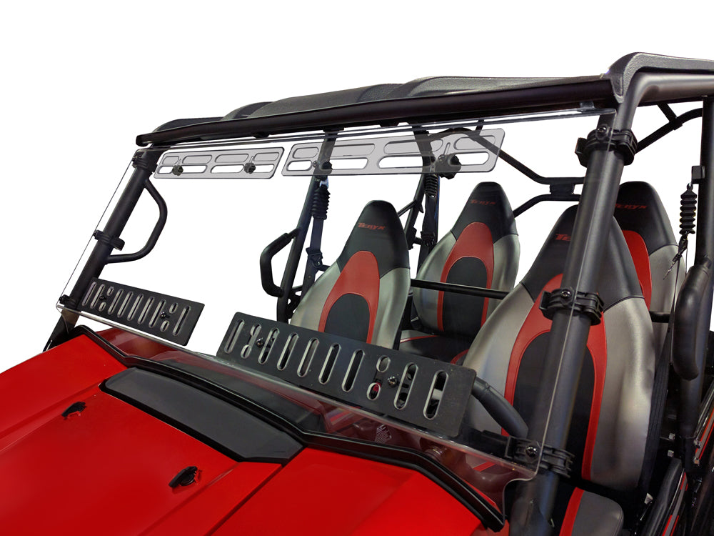 A close-up of a Kawasaki Teryx-4 featuring four bucket seats with black, gray, and red upholstery. It has a hard-coated, scratch-resistant full windshield with multi-vents and metal brackets. Shown on a white background.