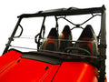 A close-up of a Kawasaki Teryx-4 / Teryx (2016+) UTV with a Short Shield-Hard Coated Scratch Resistant windshield, showing its two black seats with red accents and sporty open cabin. Plain white background highlights the vehicles design and roll bars.