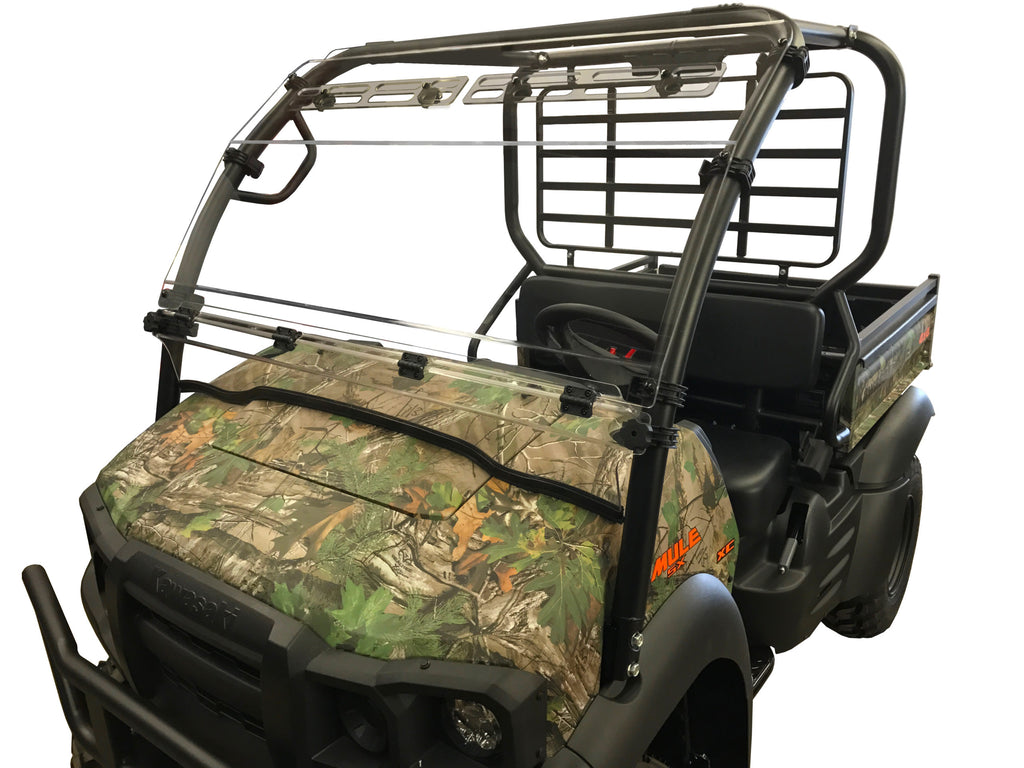 A Kawasaki Mule Sx 2017 UTV with a camouflage pattern, rugged tires, open cabin, black metal roof frame, hinged hard-coated scratch-resistant windshield with upper vents, and a protective rear cargo rack for off-road use.