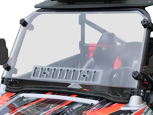 A Polaris Rzr 570/800/900 Scratch Resistant Full Venting Windshield with flip clamp and black mounting brackets is installed on an off-road vehicle with orange and black seats, showing the roll cage and harness through the windshield.