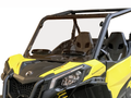 A close-up of a Can Am Maverick Trail (2018+) with a hard-coated, scratch-resistant windshield featuring dual vents, two black seats, safety bars, visible dashboard details, headlights, and “1000R” hood label.