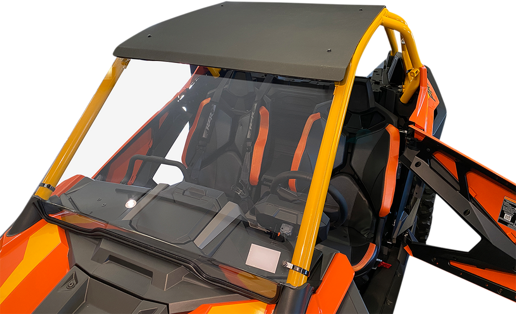Close-up view of an open orange and black off-road vehicle with yellow roll bars, a dark roof, and clear windshield. The interior features black bucket seats with orange accents and harness seat belts. The driver-side door is open, revealing the inside.