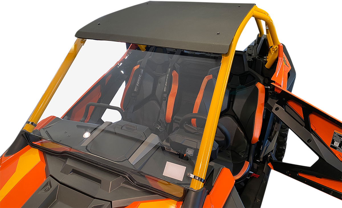 Close-up view of an open orange and black off-road vehicle with yellow roll bars, a dark roof, and clear windshield. The interior features black bucket seats with orange accents and harness seat belts. The driver-side door is open, revealing the inside.