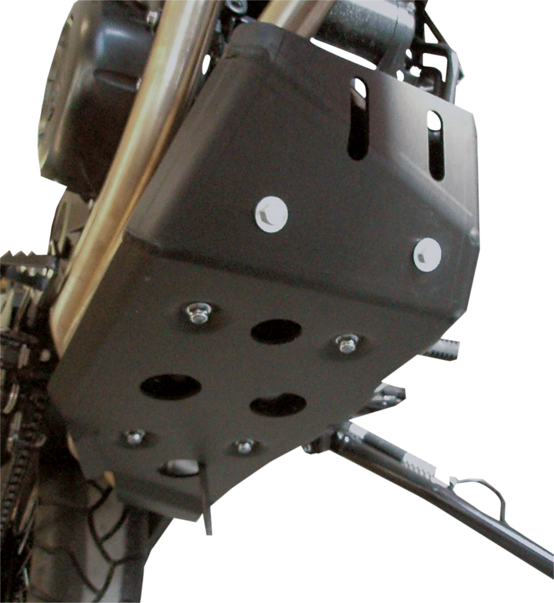 Close-up view of a black metal motorcycle skid plate mounted beneath the engine, featuring several bolts and round holes for ventilation or drainage. Part of the motorcycle’s tire and side stand are also visible. The background is plain and white.