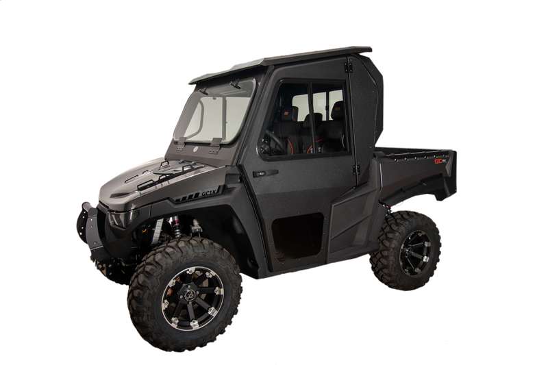 The Initmidator Gc1K Armor Tech Cab features a rugged black design with large knobby tires, angular body panels, visible suspension, a closed cab (windshield, doors, roof, back), cargo bed, and is shown on a plain white background.