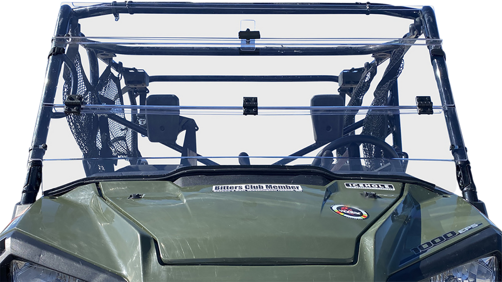 Front view of a green off-road vehicle with a transparent plastic windshield, two visible seats with mesh side panels, and several stickers on the hood, including ones reading Bitters Club Member and 1000cc. The background is plain white.
