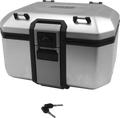 A silver, rectangular motorcycle top case with black trim and latch sits closed; two black keys rest on the white surface below, positioned near the front of the case. Four black mounting points are visible on the corners of the case’s lid.