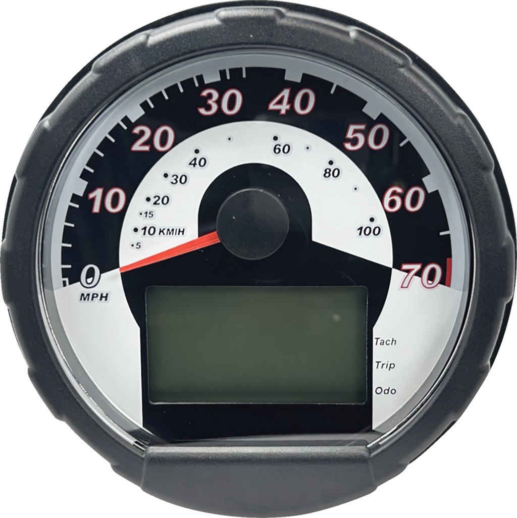 A close-up of a round analog speedometer with a black outer casing, white face, and red needle pointing to zero. Numbers 0–70 indicate speed in MPH. Below the needle is a rectangular digital display labeled “Tach,” “Trip,” and “Odo,” but the screen is bla