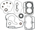 A set of various automotive gaskets and seals, including head gaskets, O-rings, valve stem seals, and circular seals, laid out neatly on a white background. Each piece has a distinct shape and is made from different materials.