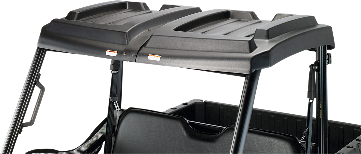 A close-up view of a black, hard plastic roof installed on an open-frame utility vehicle, showing the roofs contoured shape and support bars. The background is plain gray, making the vehicles structure and roof details clearly visible.