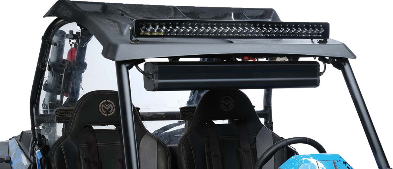 A close-up view of the upper section of an off-road vehicle with two black bucket seats, a roof-mounted LED light bar, and a horizontal device mounted under the roof. The roll cage and part of the blue hood are visible. The background is plain white.