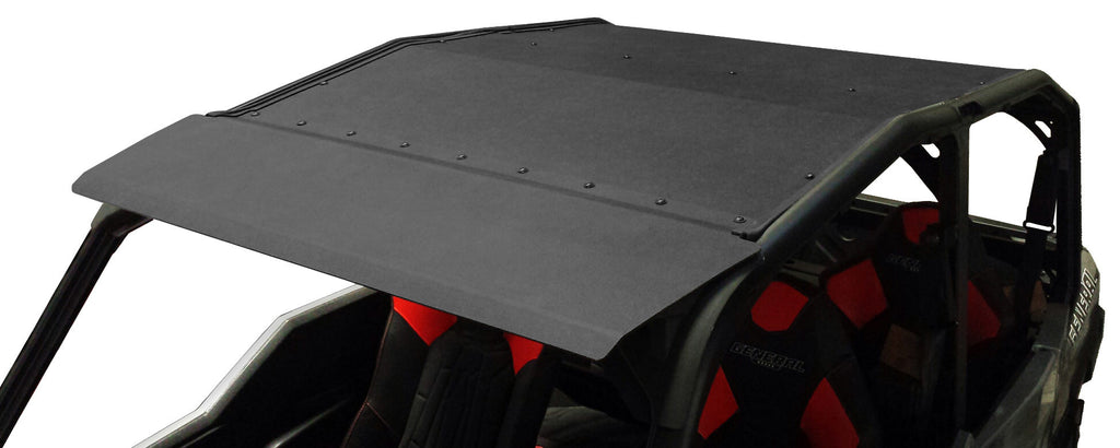 A close-up of the Polaris General-4 ABS Roof 2017+ installed on an off-road utility vehicle with an open cabin, featuring red and black padded seats. The black roof is secured with visible bolts along its edges.