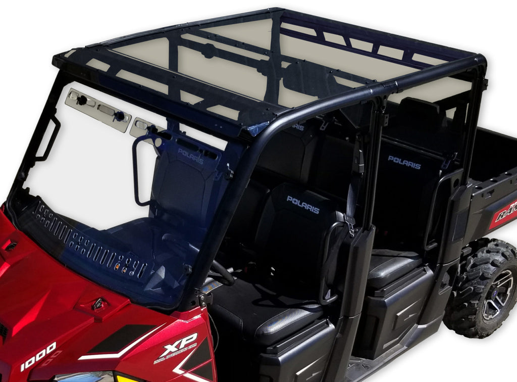 A Polaris Ranger Full-Size Crew with a 2-piece tinted polycarbonate roof (Pro-Fit Tubing) is shown from above at an angle, featuring rugged tires, visible side mirrors, black trim, and four “Polaris”-labeled seats.