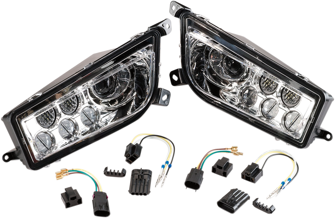 A pair of car LED projector headlights with clear lenses and black housings, displayed side by side. In front of the headlights are wiring harnesses, electrical connectors, and adapters arranged neatly on a white background.