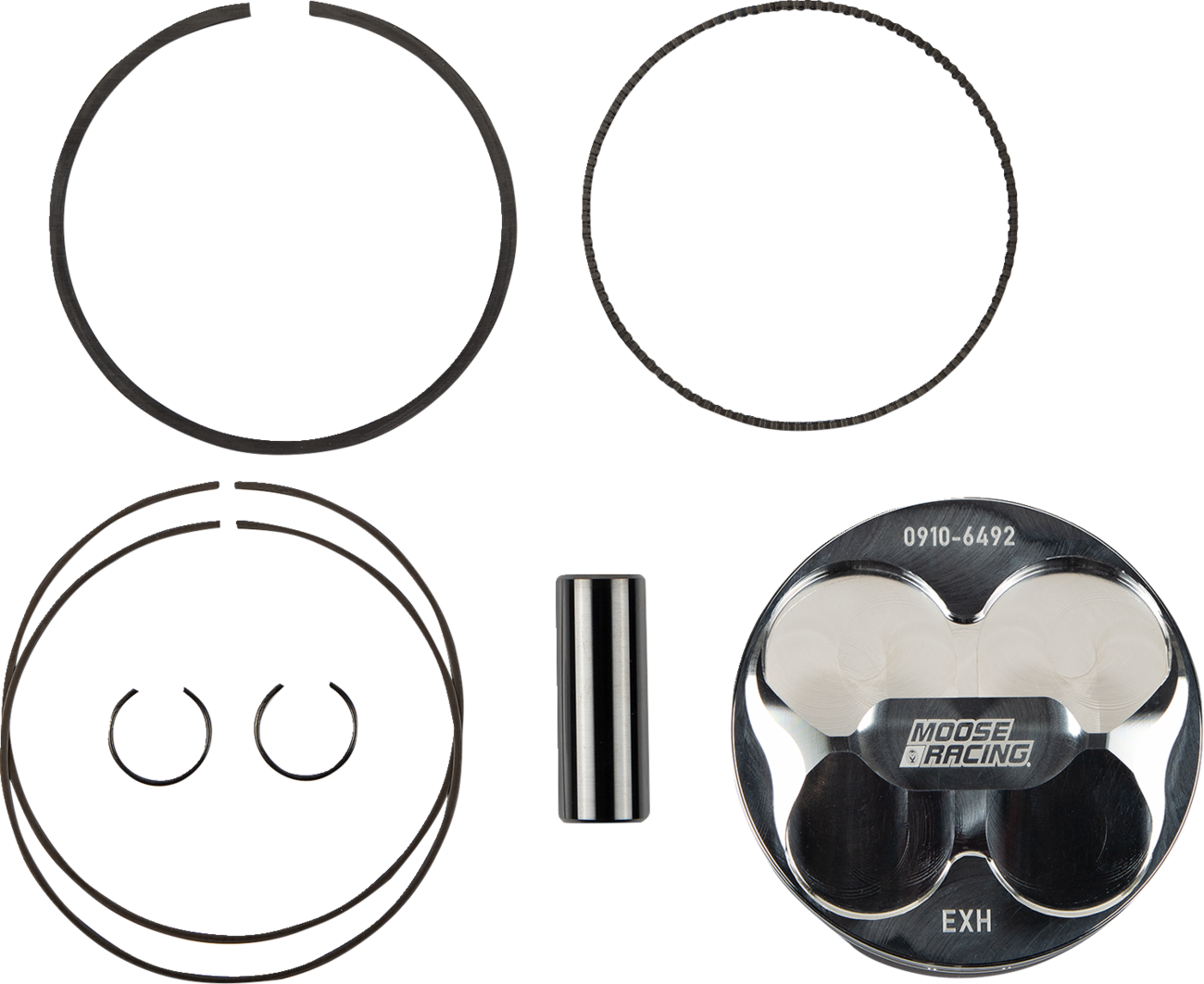 A set of engine parts on a white background, including piston rings, two C-clips, a cylindrical piston pin, and a silver piston labeled MOOSE RACING with EXH and 0910-6492 engraved, all arranged in an organized layout.