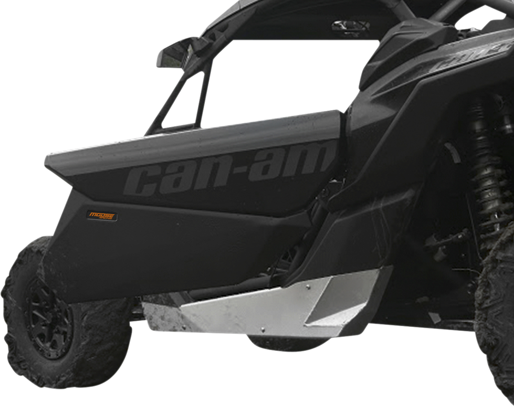 A close-up side view of a black Can-Am off-road vehicle, focusing on the door with can-am text in gray. The vehicle has rugged tires, a visible suspension coil, and a metallic silver skid plate beneath the door for protection.