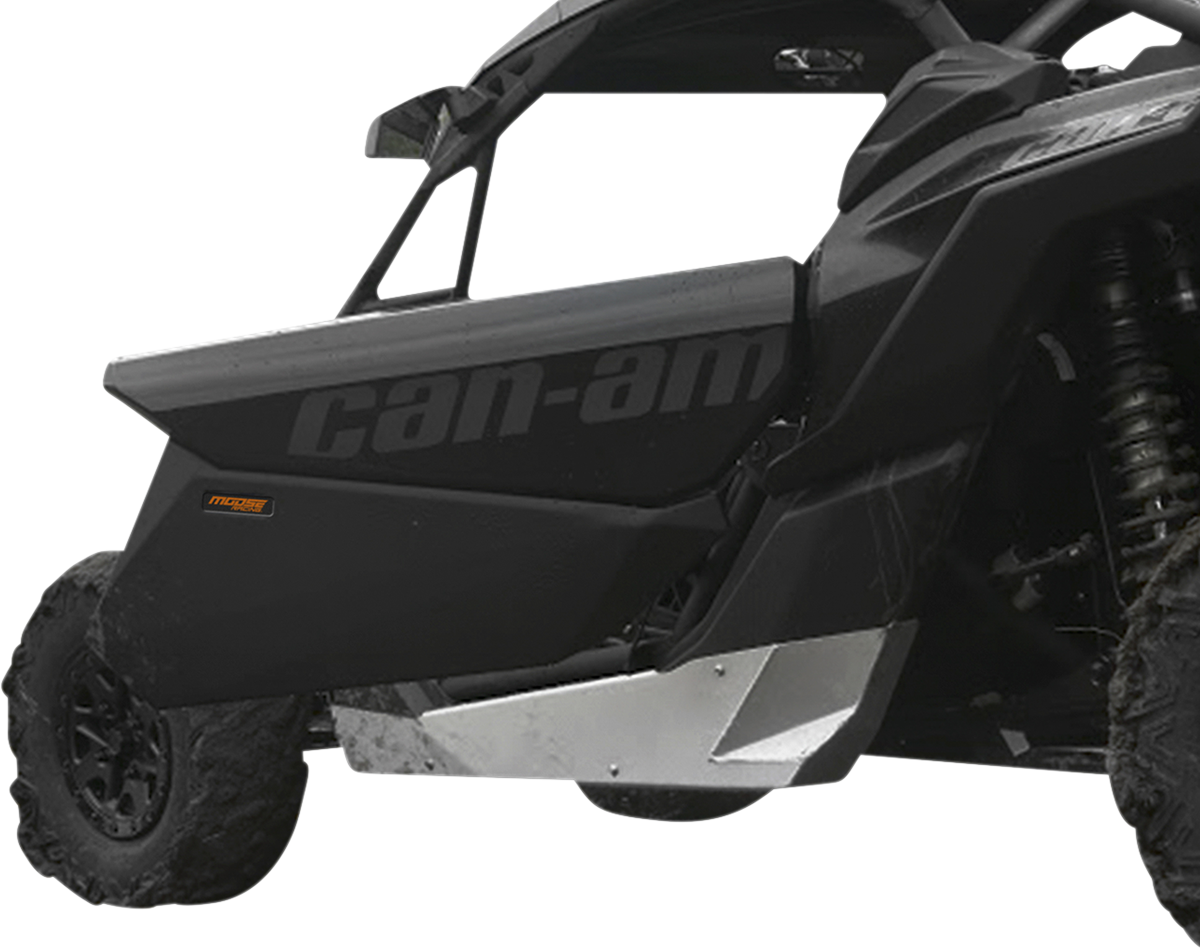 A close-up side view of a black Can-Am off-road vehicle, focusing on the door with can-am text in gray. The vehicle has rugged tires, a visible suspension coil, and a metallic silver skid plate beneath the door for protection.
