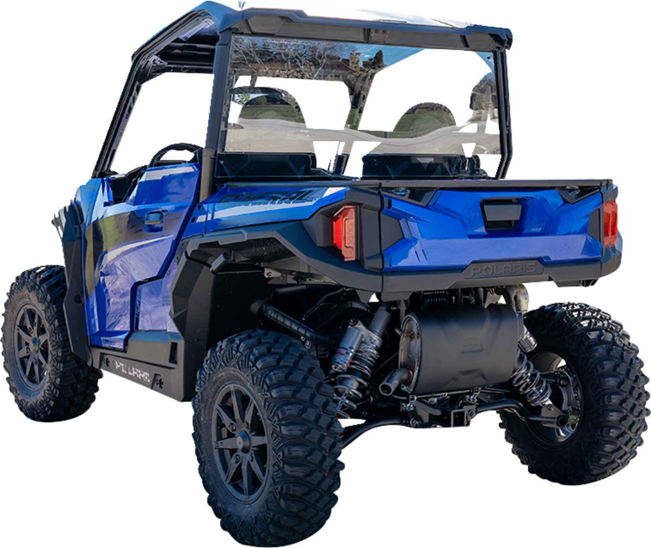 A blue Polaris off-road utility vehicle with rugged tires, black roof, and rear cargo area is shown from a rear angled view. The suspension and undercarriage are visible, and two seats with seatbelts are seen inside through the clear rear window.