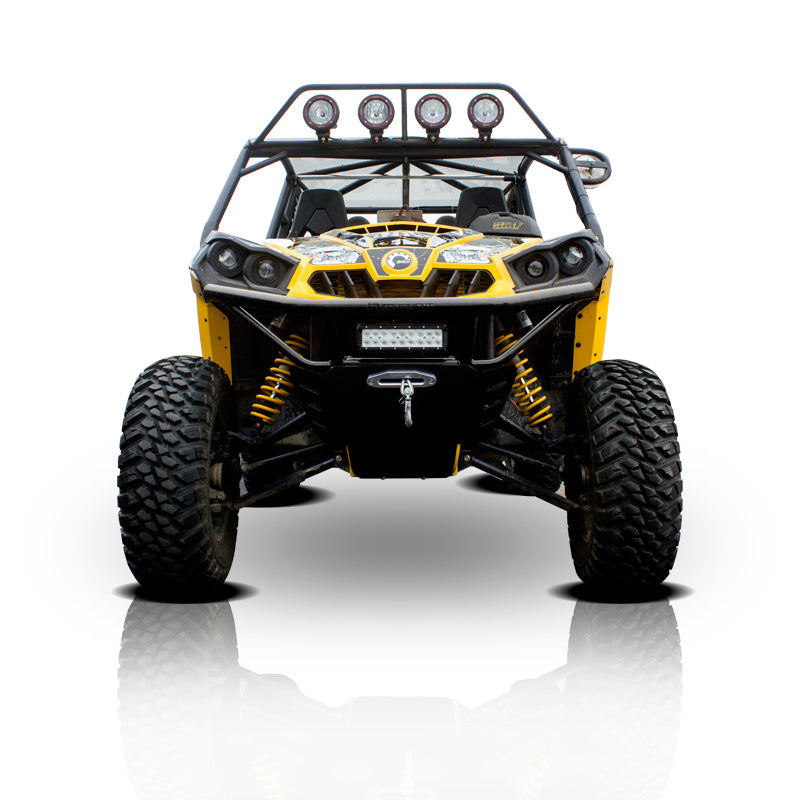 A Can Am Commander HMF Front Heavy Duty Bumper (2011-2020) is displayed from the front, showing off its rugged build and visible suspension, with large tires and a reflection below on a white background.