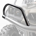 Close-up of black Can Am Commander HMF Headlight Guards (2011-2020) mounted to an ATV/UTV, with the vehicle’s headlights, grille, and rugged tire partially visible in the background. The guards are in sharp focus; the rest is faded.