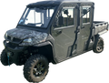 A dark green, rugged side-by-side UTV with four doors, large off-road tires, a winch on the front bumper, and a utility bed in the rear. The vehicle has a hard roof, side mirrors, and tinted windows, designed for outdoor and utility use.