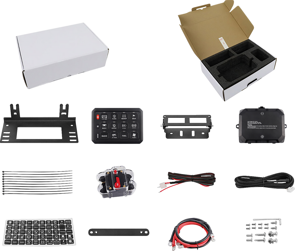 An assortment of vehicle electronic kit components arranged neatly: two white boxes (one open with foam inserts), metal brackets, a switch panel, wiring, a breaker, zip ties, small screws, cable labels, and mounting hardware, all displayed on a white back