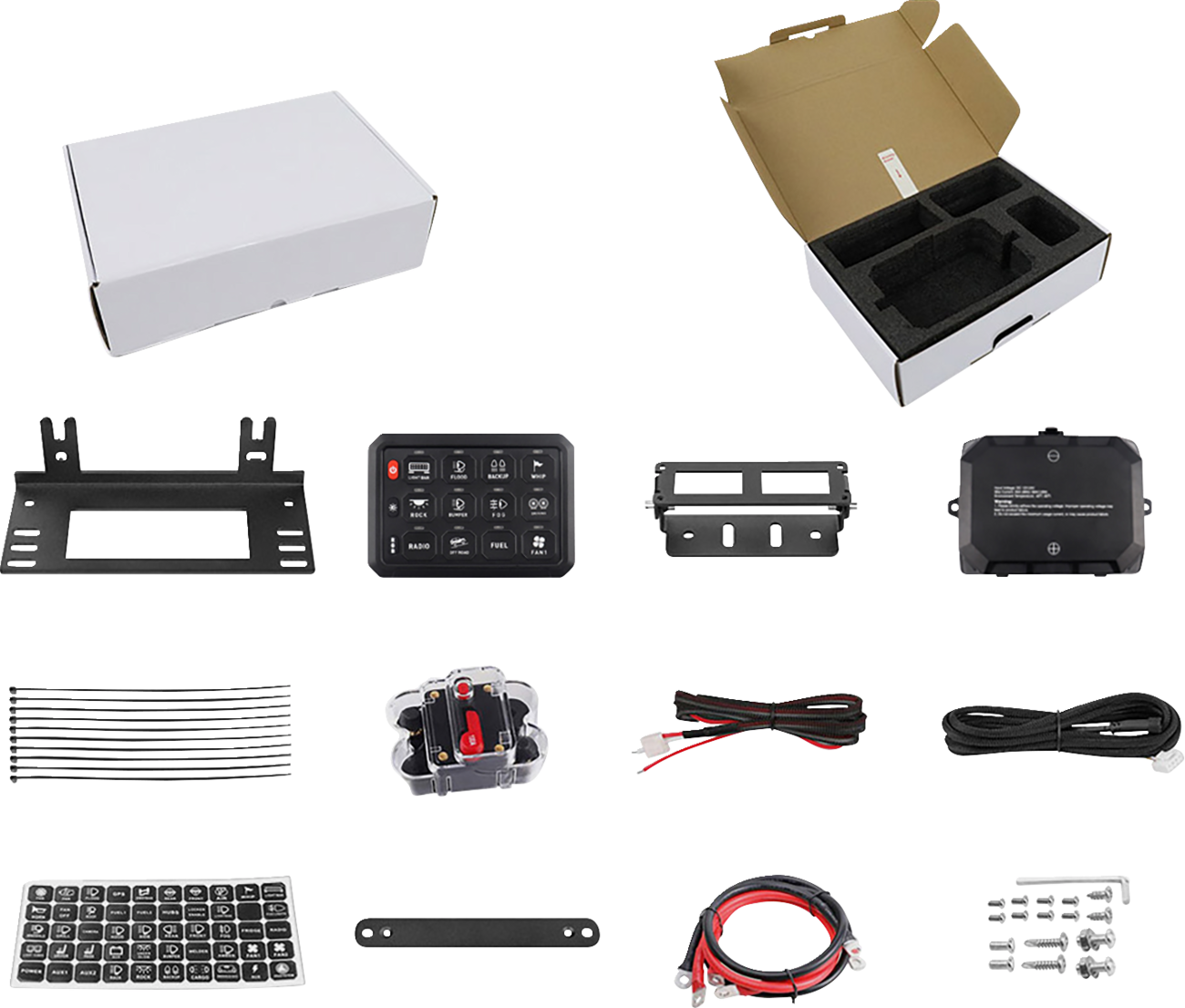 An assortment of vehicle electronic kit components arranged neatly: two white boxes (one open with foam inserts), metal brackets, a switch panel, wiring, a breaker, zip ties, small screws, cable labels, and mounting hardware, all displayed on a white back