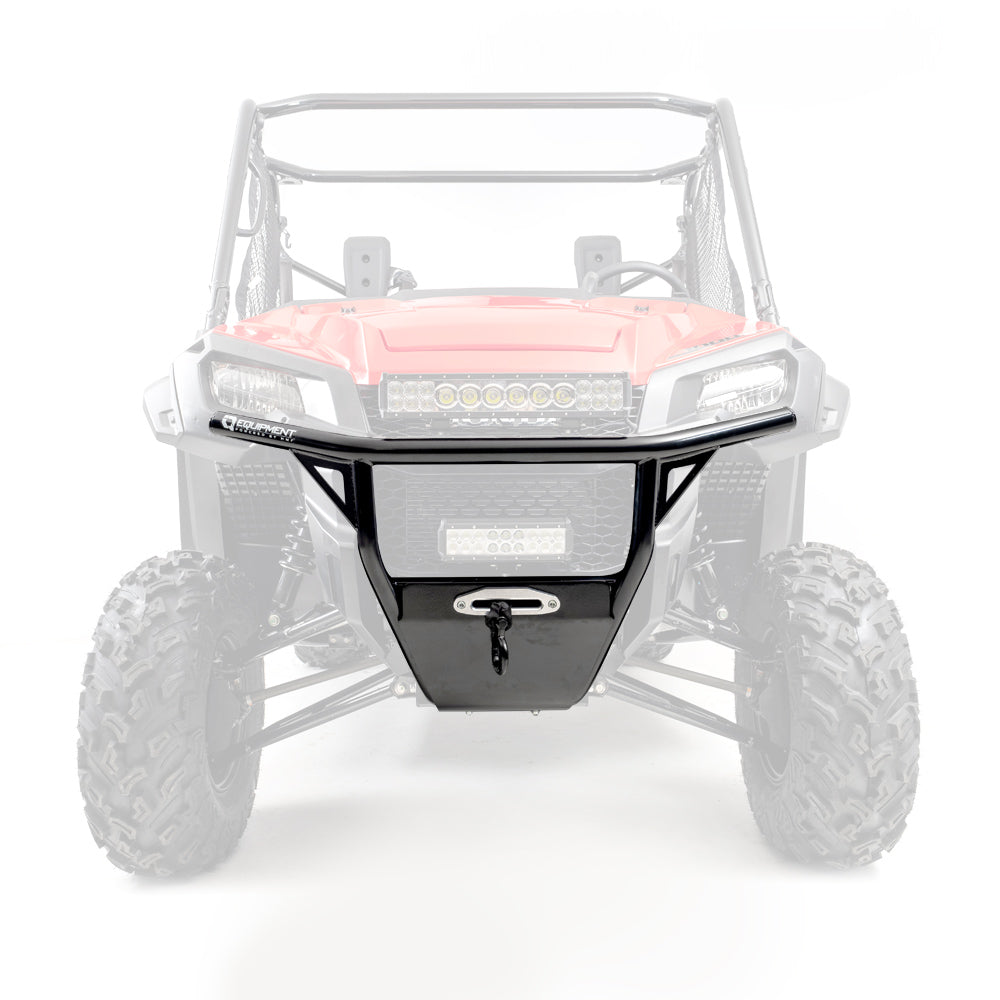 Front view of a Honda Pioneer 1000 with a black HMF Defender Front Heavy Duty Bumper (2016+), featuring mesh panels and tow hook, attached to its red front end. The background and the rest of the vehicle are faded to highlight the bumper.