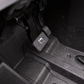 Close-up of a clean, dark driver’s footwell featuring the Polaris Rzr Rs1 HMF Brake Pedal - Black 2018+ mounted on a metal bracket, with visible screws, ridged rubber grip, and a textured black floor mat.