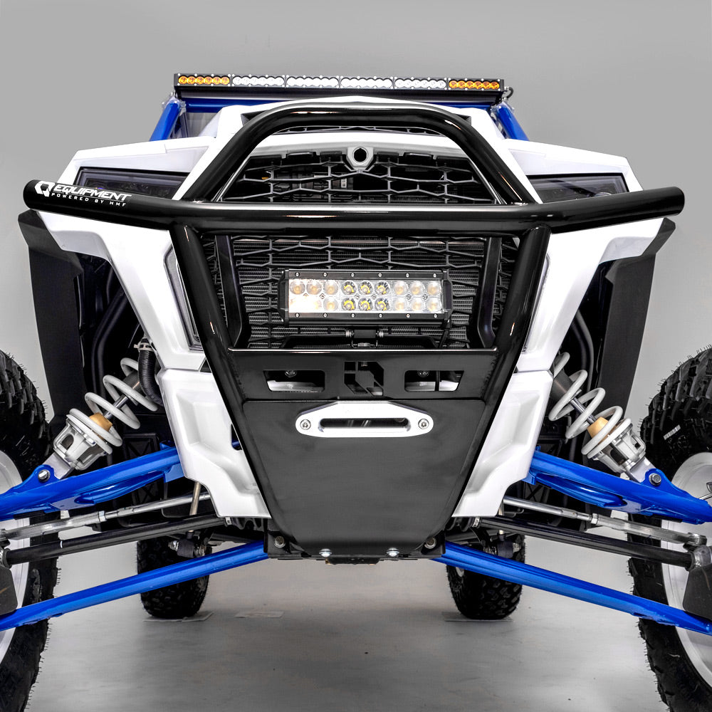 Close-up of a Polaris Rzr Turbo | S | Xp1K Hmf Defender Front Heavy Duty Bumper (2019+) featuring a black metal bumper, LED light bar, white and blue suspension parts, large tires, and skid plate against a neutral gray background.