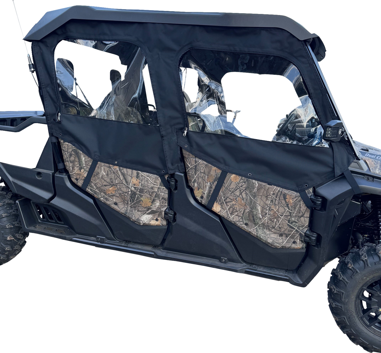 A close-up side view of a rugged off-road vehicle with two doors featuring black fabric and clear plastic windows. The lower half of the doors displays a camouflage pattern. The vehicle has sturdy tires and an angular design, suitable for outdoor terrain.