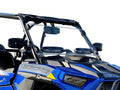 A close-up view of a 2019+ Rzr Xp 1000 with a scratch resistant venting windshield, clear glass, black roll bars, side mirrors, mounted speakers, and 1000 on the hood. The vehicle is blue with a plain white background.