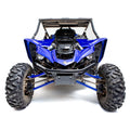 A front view of a Yamaha YXZ 1000R (2016+) featuring the HMF Defender heavy duty black front bumper, with rugged tires, exposed suspension, protective roof, sporty angular design, headlights, visible engine parts, and Yamaha logo on the nose.
