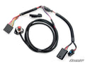 The Polaris UTV Dynojet Throttle Commander features a black wiring harness with multi-colored wires and connectors, a red push button switch on a metal plate, and bundled protective tubing. “SuperATV” appears in the bottom right corner.