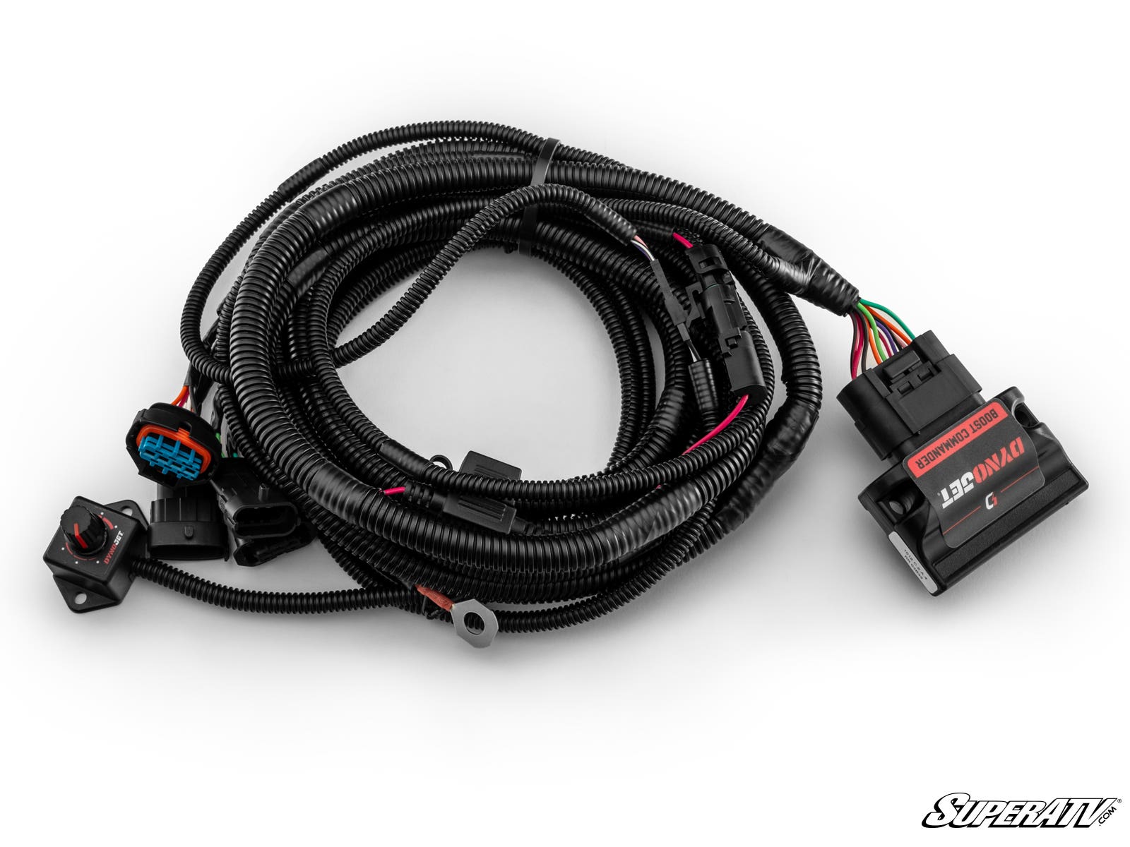 The Can-Am Maverick X3 RR Dynojet Boost Commander Kit features a black, coiled wiring harness with multiple connectors, an attached 12V SuperATV control module, protective tubing, and the SuperATV logo in the bottom right corner.
