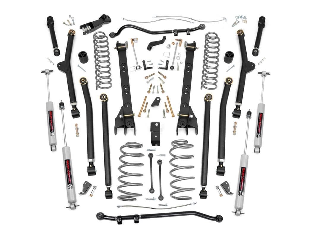 The 4 Inch Lift Kit | Long Arm for Jeep Wrangler TJ 4WD (1997-2006) is displayed on a white background with control arms, coil springs, shocks, sway bars, brackets, bolts, and hardware arranged symmetrically for clear visibility.