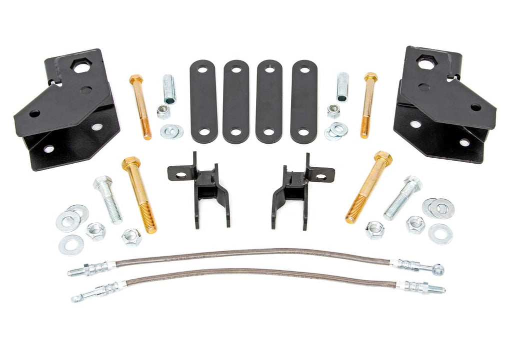 A 2 Inch Lift Kit for Mahindra Roxor featuring black metal brackets, plates, bolts, nuts, washers, and two braided steel hoses neatly arranged on a white background—ideal components for easy vehicle installation.