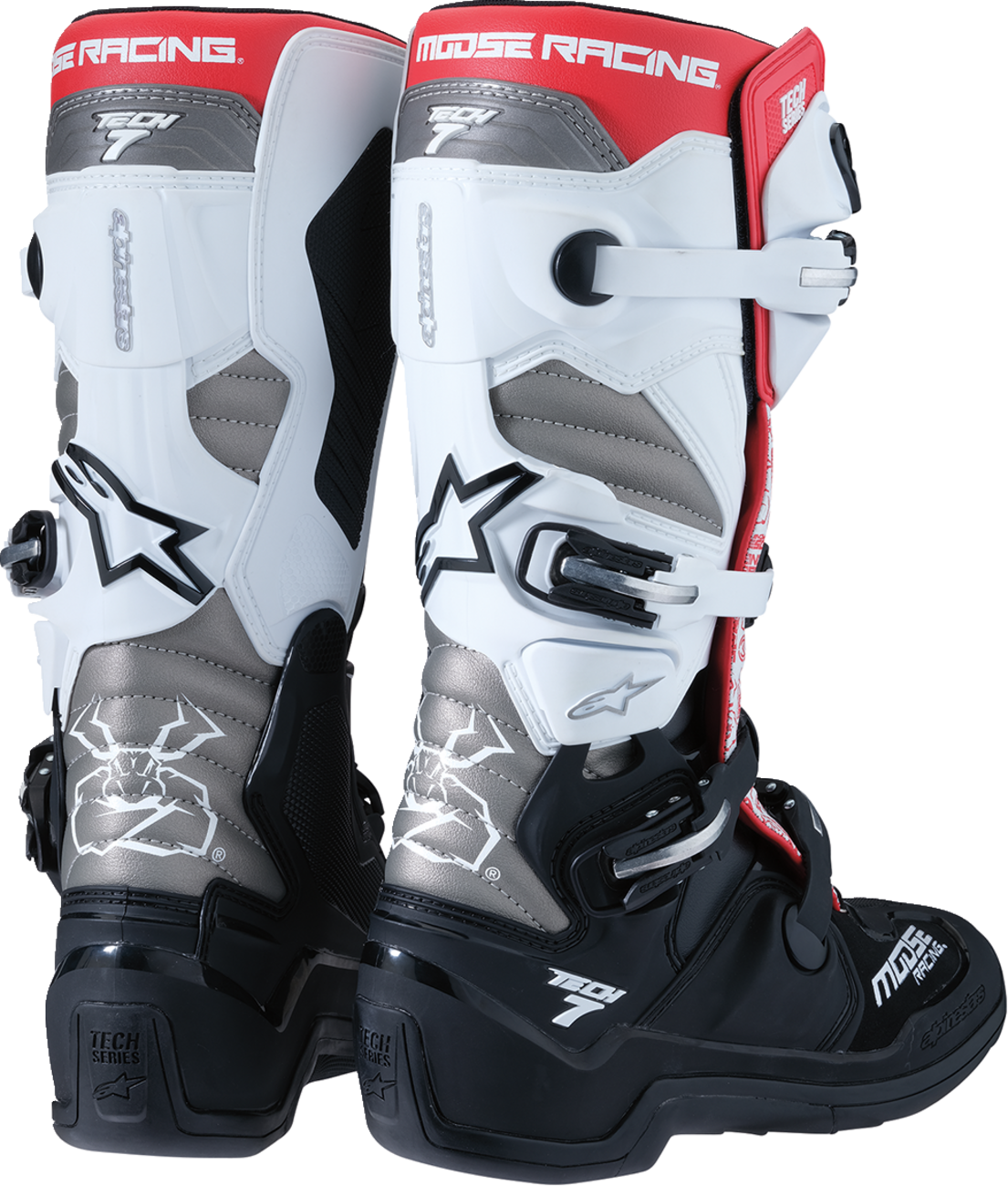 A pair of Moose Racing motocross boots, primarily black, white, and silver, with red accents. The boots feature multiple buckles, textured panels, and bold logos, offering ankle and shin protection for off-road motorcycle riding.