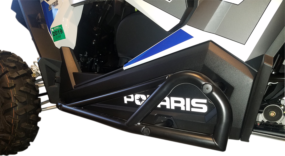 Close-up of a black off-road vehicle’s side, showing a tubular nerf bar and the word “POLARIS” in bold white letters. Part of a tire, the door panel, and blue, white, and gray graphics are visible, along with a green registration sticker.