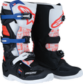 A pair of motocross boots with black, white, red, and blue accents. They feature bold graphics, metal buckles, protective panels, and reinforced soles. The boots have prominent branding and are designed for off-road motorcycle riding.