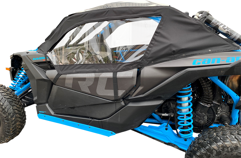 A close-up side view of a black and blue off-road vehicle with large rugged tires, blue suspension springs, and a transparent plastic window in a black fabric door cover. The word “Can-am” is visible along the top edge of the door.
