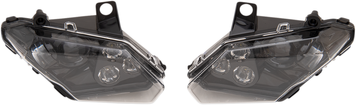 Two black and clear angular headlight assemblies are shown facing each other on a white background. Each headlight has three visible circular bulbs inside, with mounting tabs on the top edge of both units.