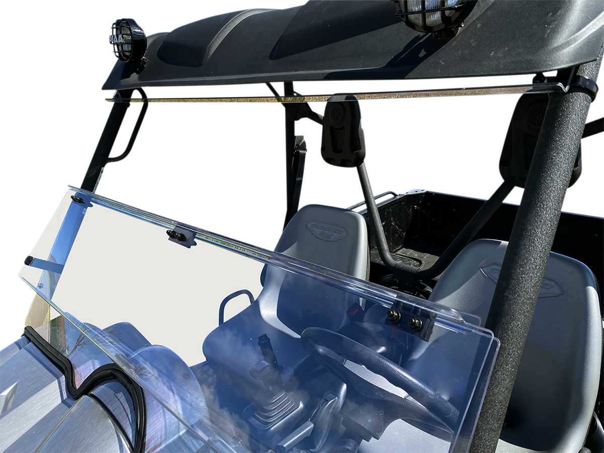 A clear, split windshield is installed on a black off-road utility vehicle. The windshield has two sections, with the top section tilted open. The image focuses on the windshield and front seats, with the steering wheel and dashboard visible.