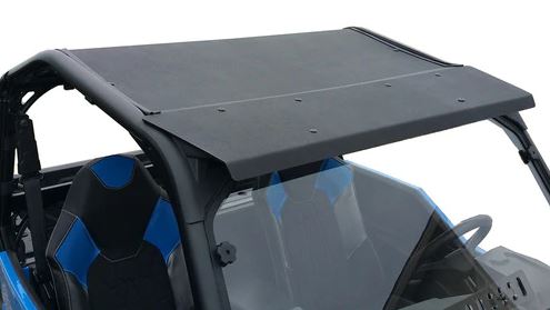 A close-up of a Polaris General ABS Roof 2016+ in black on a blue and black off-road vehicle, showing part of the windshield, frame, and two bucket seats. Bolts are visible along the roof edge against a plain white background.