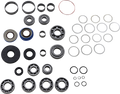 A collection of mechanical parts arranged on a white background, including various sizes of ball bearings, needle bearings, oil seals, rubber O-rings, and metal washers. The components are neatly grouped by type and size in a grid-like pattern.