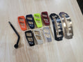 The Can-Am Defender HD8, HD9, or HD10 Ultimate Shifter Kit is displayed on light wood, featuring a black gear lever and colorful shift plates in red, orange, yellow, green, black, silver, clear, gray plus two metallic shift pattern plates.