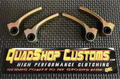 Four metallic clutch arms with black circular holes are arranged in an arc on a textured black surface. Below them is the Maverick Trail/Sport Clutch Kit sign from QuadShop Customs, stating HIGH PERFORMANCE CLUTCHING and GETTING POWER TO THE GROUND WITH Q